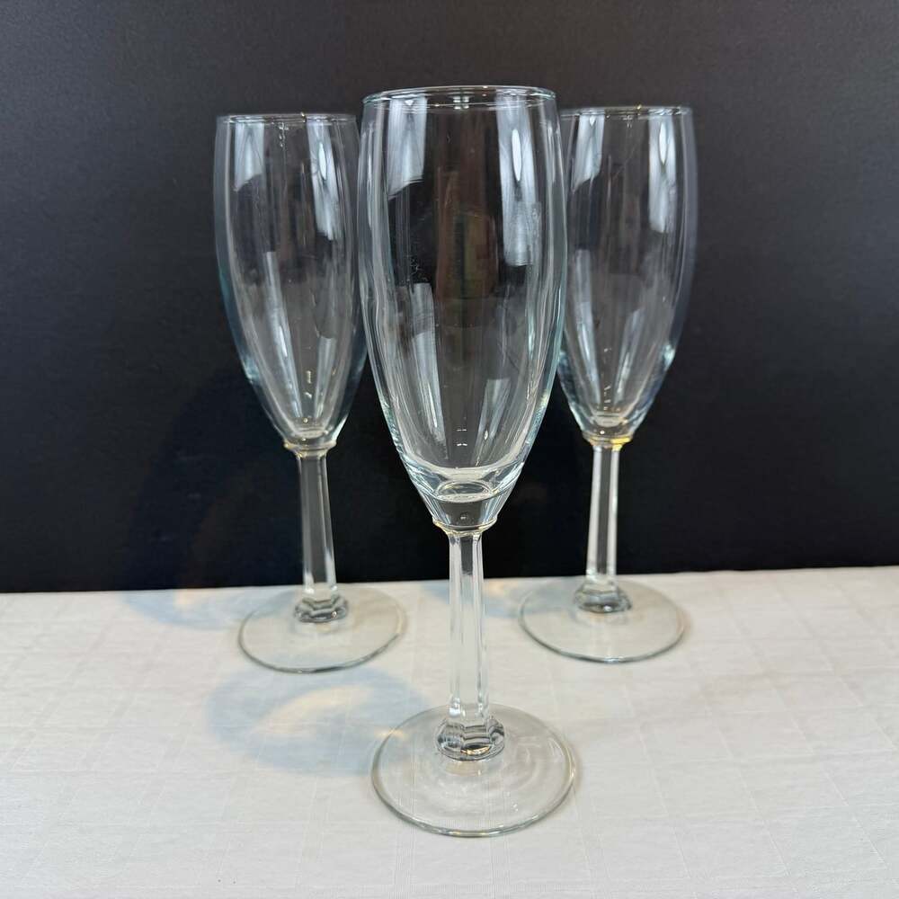 Set of 3 clear glass champagne flutes with paneled stems